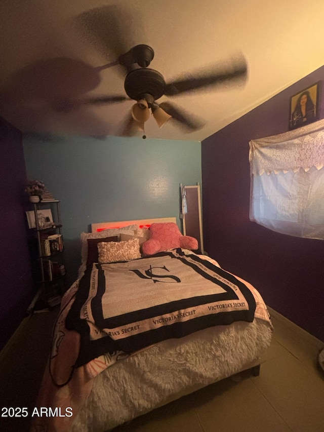 tiled bedroom featuring ceiling fan