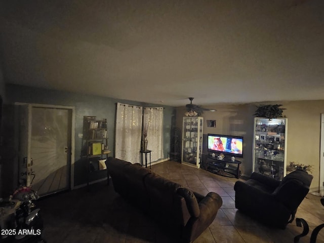 living area with ceiling fan and tile patterned floors