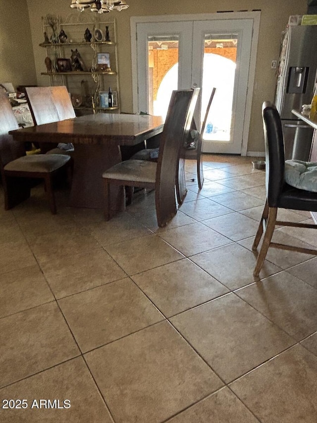 dining space featuring french doors and tile patterned floors