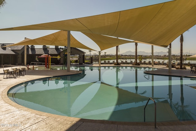 view of swimming pool featuring a patio area and a mountain view