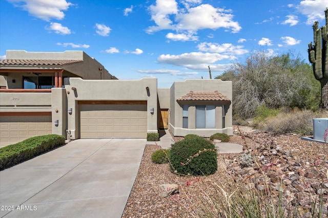 12642 N Mountainside Dr Unit D, Fountain Hills, AZ 85268 - adobe home with a tile roof, stucco siding, a garage, and driveway