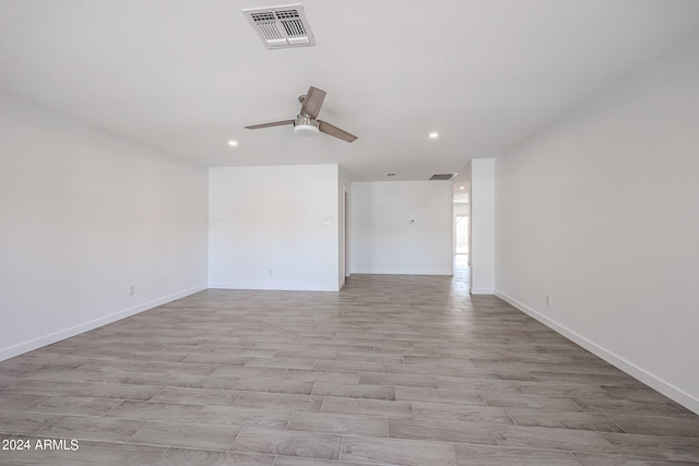 unfurnished room with ceiling fan and light wood-type flooring