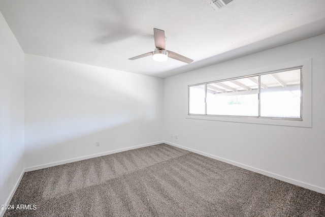 carpeted empty room with ceiling fan