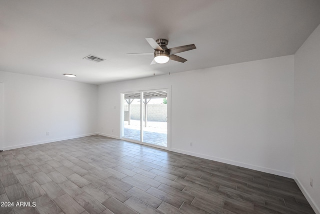 empty room with dark wood-type flooring and ceiling fan