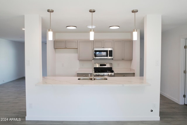 kitchen with dark hardwood / wood-style floors, decorative light fixtures, gray cabinets, and stove