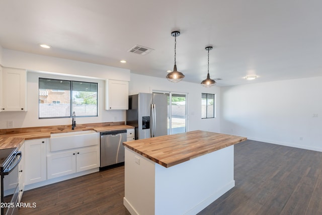 2818 E Villa Rita Dr, Phoenix, AZ 85032 - kitchen with butcher block countertops, appliances with stainless steel finishes, a sink, plenty of natural light, and recessed lighting