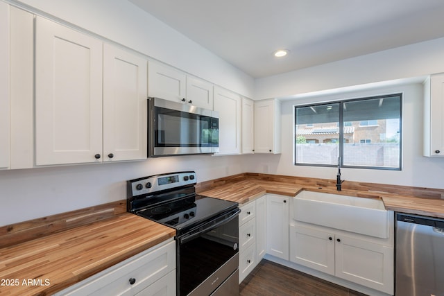 2818 E Villa Rita Dr, Phoenix, AZ 85032 - kitchen featuring butcher block countertops, appliances with stainless steel finishes, a sink, white cabinetry, and recessed lighting