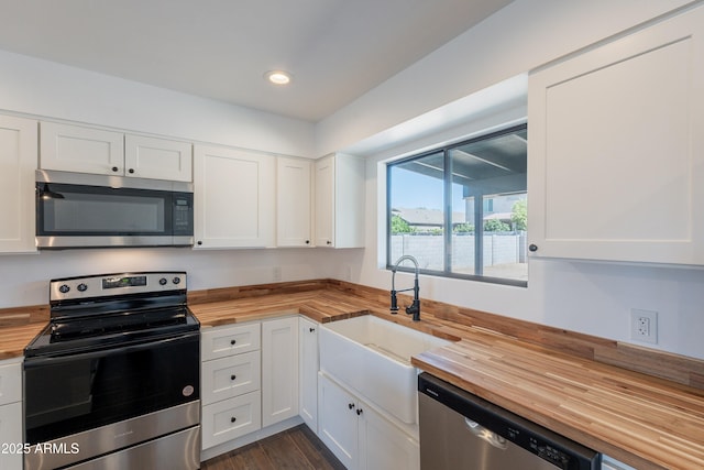 2818 E Villa Rita Dr, Phoenix, AZ 85032 - kitchen featuring butcher block counters, stainless steel appliances, a sink, white cabinetry, and recessed lighting