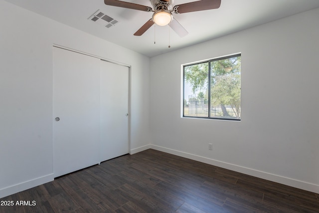 2818 E Villa Rita Dr, Phoenix, AZ 85032 - unfurnished bedroom featuring dark wood finished floors, baseboards, a closet, and ceiling fan