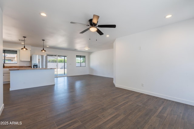 2818 E Villa Rita Dr, Phoenix, AZ 85032 - unfurnished living room featuring a ceiling fan, baseboards, dark wood-type flooring, and recessed lighting