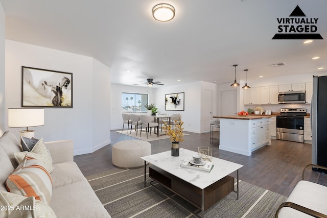 2818 E Villa Rita Dr, Phoenix, AZ 85032 - living room with recessed lighting, dark wood finished floors, ceiling fan, and baseboards