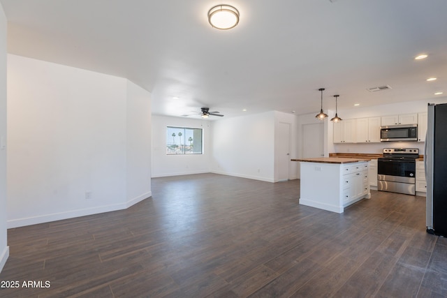 2818 E Villa Rita Dr, Phoenix, AZ 85032 - kitchen with appliances with stainless steel finishes, wooden counters, open floor plan, recessed lighting, and ceiling fan