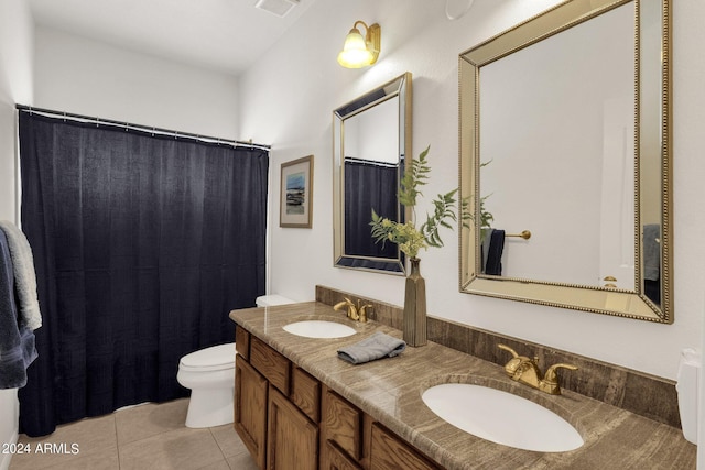 full bathroom featuring double vanity, toilet, tile patterned flooring, and a sink
