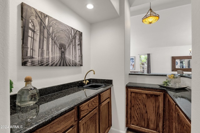 bar featuring decorative light fixtures, recessed lighting, and a sink
