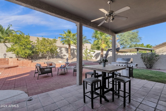 view of patio featuring a ceiling fan, a fenced backyard, outdoor dining area, and grilling area