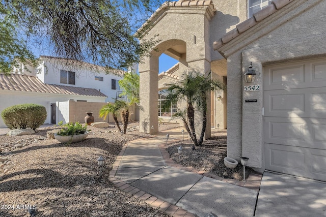 view of property's community with fence and a garage
