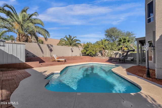 view of swimming pool featuring a fenced in pool, a patio area, and a fenced backyard