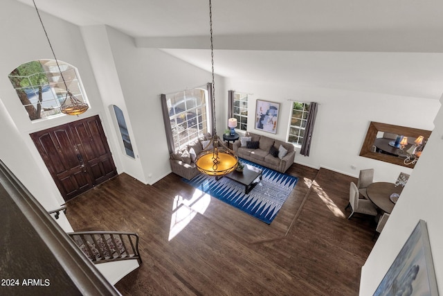 living room with wood finished floors, high vaulted ceiling, and baseboards