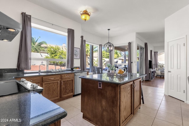 kitchen with light tile patterned floors, decorative light fixtures, dishwasher, a sink, and a center island