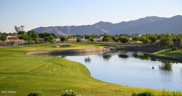 view of community featuring a water and mountain view, a yard, and golf course view