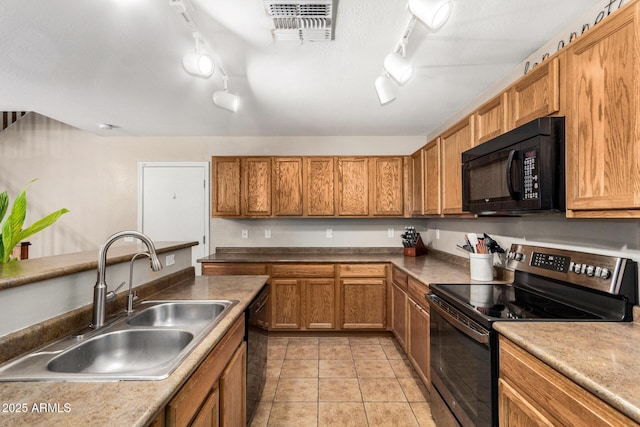 942 S Deerfield Ln, Gilbert, AZ 85296 - kitchen with black appliances, track lighting, brown cabinetry, and light tile patterned floors