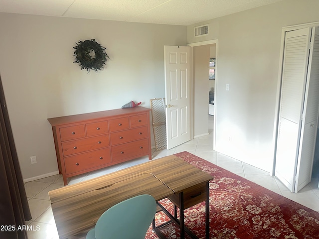 4201 E Camelback Rd Unit 51, Phoenix, AZ 85018 - bedroom with light tile patterned flooring and baseboards