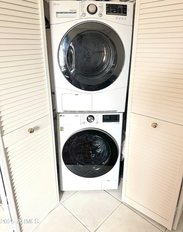 4201 E Camelback Rd Unit 51, Phoenix, AZ 85018 - laundry room with stacked washer / dryer and light tile patterned flooring