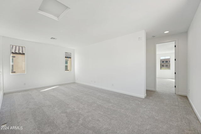 spare room featuring light colored carpet