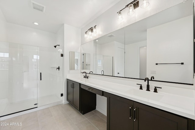 bathroom with tile patterned flooring, vanity, and a shower with shower door