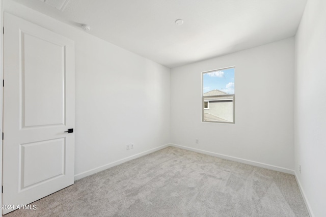 empty room featuring light carpet