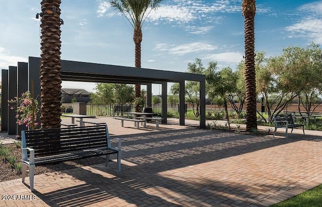 view of property's community with a patio and a pergola