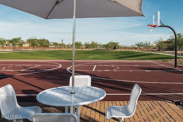 view of sport court featuring a yard