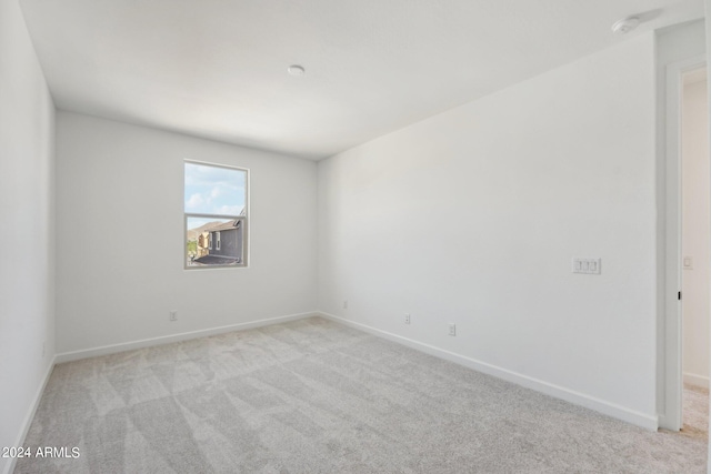 empty room featuring light carpet