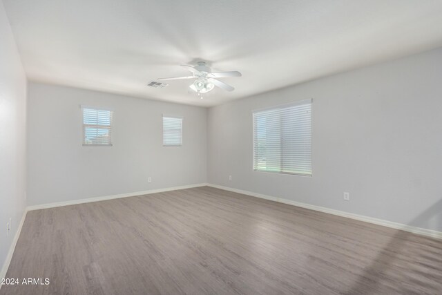 spare room featuring light hardwood / wood-style flooring and ceiling fan