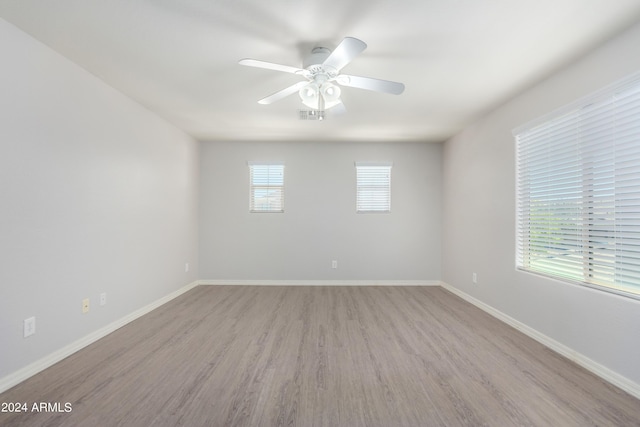 spare room featuring light hardwood / wood-style flooring and ceiling fan