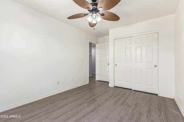 unfurnished bedroom featuring ceiling fan, light hardwood / wood-style floors, and a closet