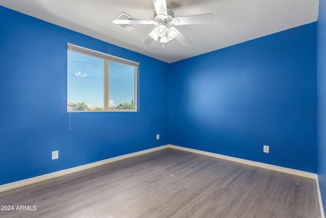 unfurnished room with hardwood / wood-style flooring and ceiling fan