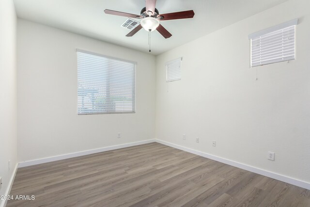 spare room featuring hardwood / wood-style floors and ceiling fan