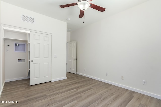 unfurnished bedroom with ceiling fan, light hardwood / wood-style floors, and a closet