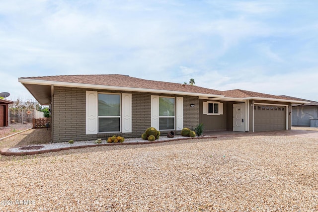 13842 N Tan Tara Dr, Sun City, AZ 85351 - ranch-style home with fence, a garage, brick siding, and concrete driveway