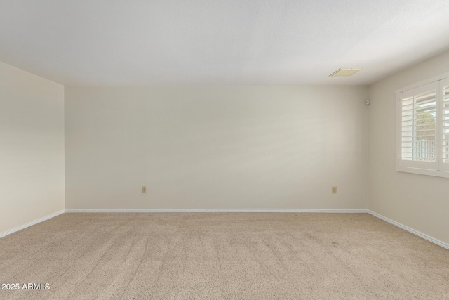 13842 N Tan Tara Dr, Sun City, AZ 85351 - spare room featuring baseboards, visible vents, and light colored carpet