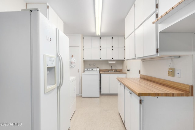13842 N Tan Tara Dr, Sun City, AZ 85351 - kitchen with light countertops, white cabinetry, white fridge with ice dispenser, light floors, and washer / dryer