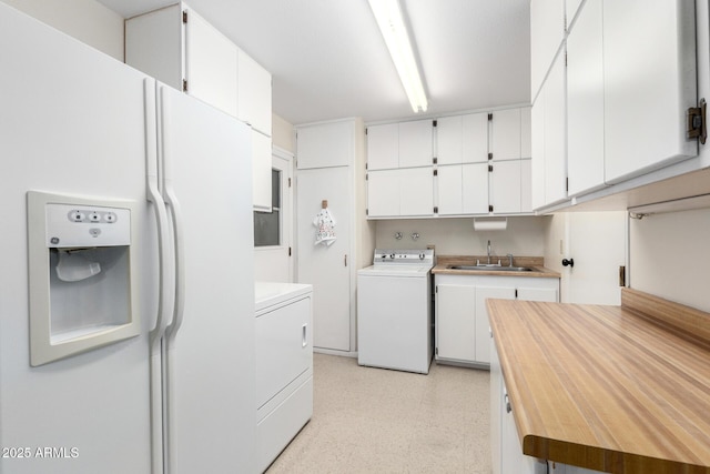 13842 N Tan Tara Dr, Sun City, AZ 85351 - laundry room featuring cabinet space, a sink, washer and dryer, and light floors