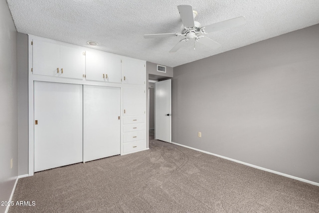 13842 N Tan Tara Dr, Sun City, AZ 85351 - unfurnished bedroom with carpet, a closet, a textured ceiling, and visible vents