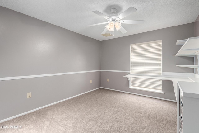 13842 N Tan Tara Dr, Sun City, AZ 85351 - spare room with carpet flooring, a ceiling fan, baseboards, and a textured ceiling