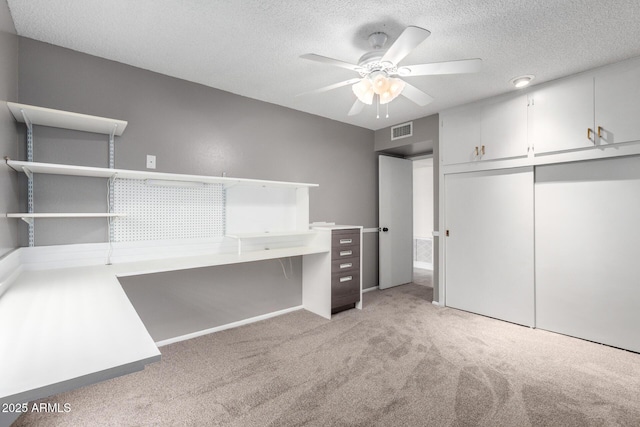13842 N Tan Tara Dr, Sun City, AZ 85351 - unfurnished bedroom with a textured ceiling, visible vents, a ceiling fan, light carpet, and a closet