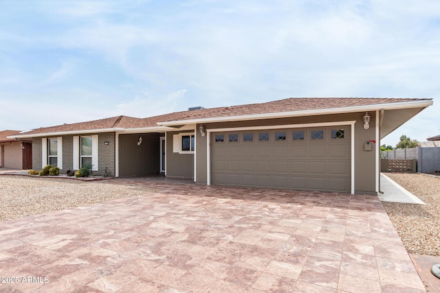 13842 N Tan Tara Dr, Sun City, AZ 85351 - single story home with decorative driveway, a garage, and fence