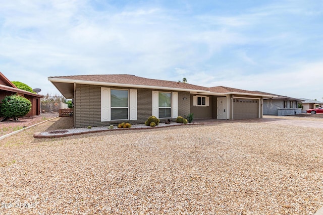 13842 N Tan Tara Dr, Sun City, AZ 85351 - single story home with a garage, brick siding, and concrete driveway