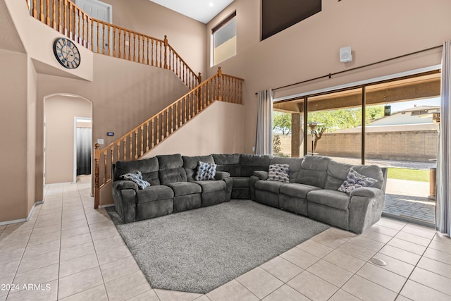 tiled living room with a high ceiling