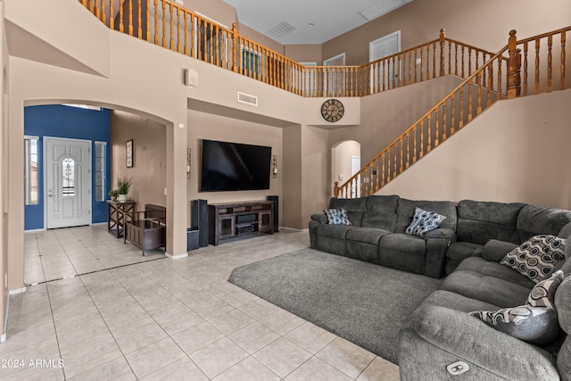 tiled living room with a high ceiling